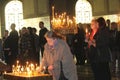 People light candles during festive prayer in church Royalty Free Stock Photo